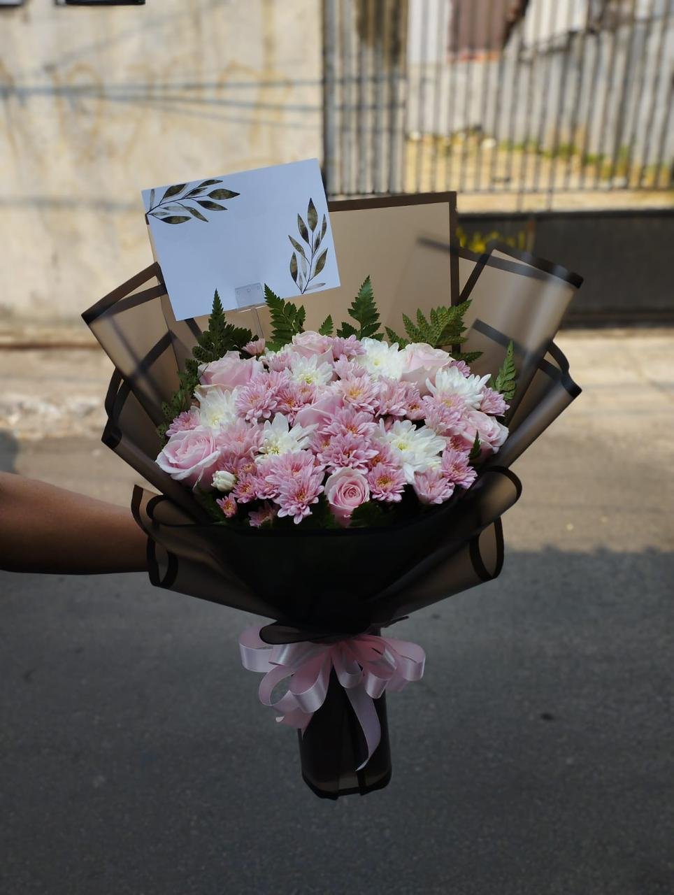 Hand bouquet chrysanthemum pink putih dan mawar dengan wrap kertas hitam transparan pita pink untuk wisuda